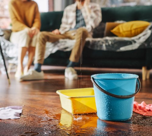 Residential Water Leak Indoors With Buckets And Towels