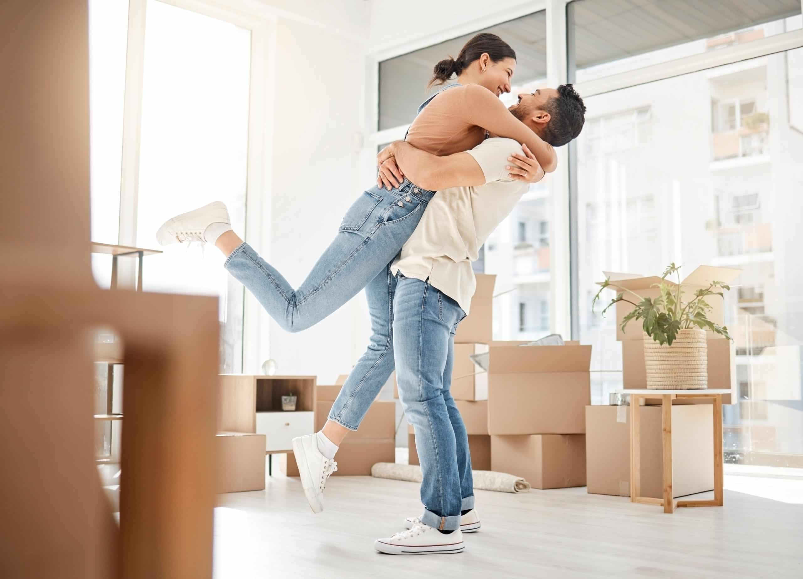 A couple celebrating their belongings being saved by content restoration services.